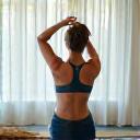 Contented client Sophia R. stretching gracefully.